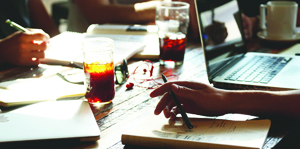 Close up of table with notebooks and a laptop